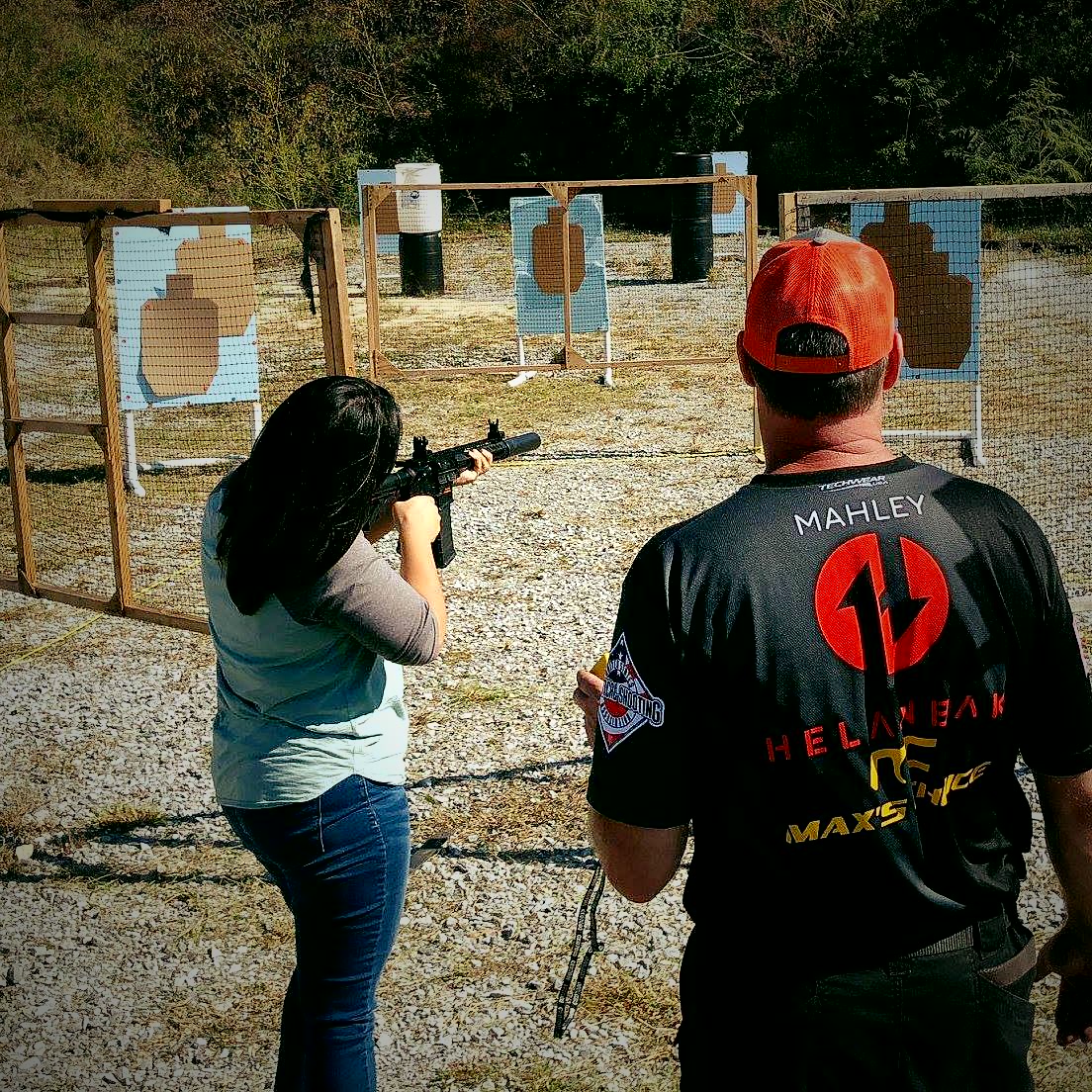 Helanbak staff coaching a shooter at the range